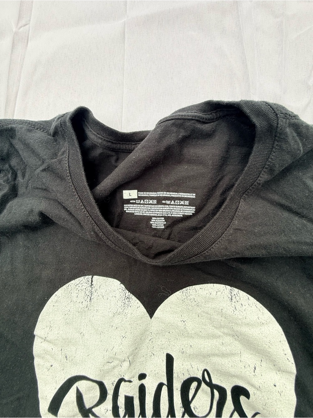 #57 size(L) Women's Black Short-Sleeve Graphic Tee with White Heart 'Raiders' - Picture 2 of 5